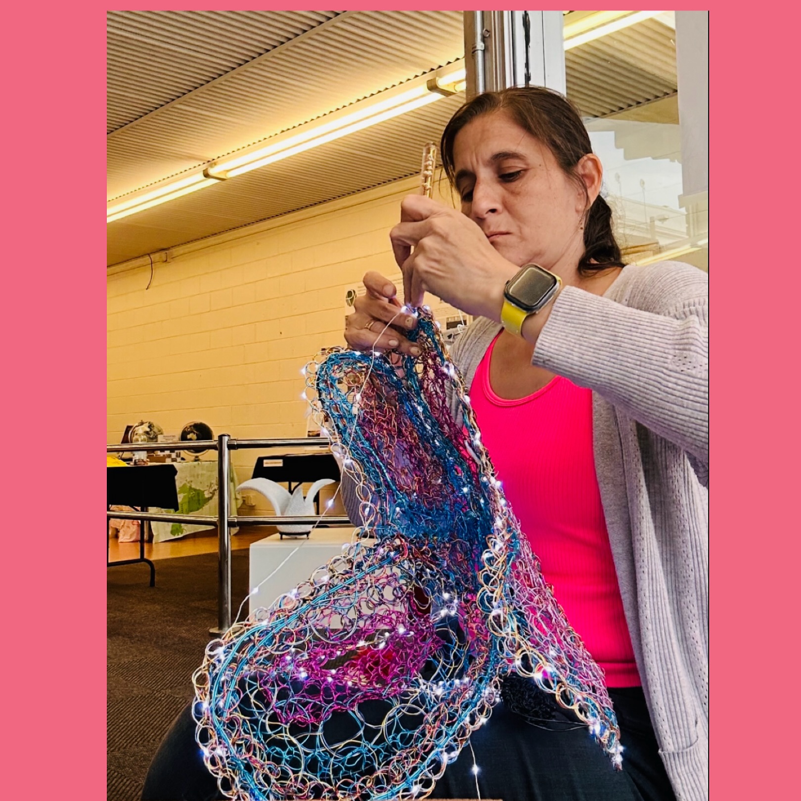 Marita Valdizan hand-crafting an illuminated wire sculpture